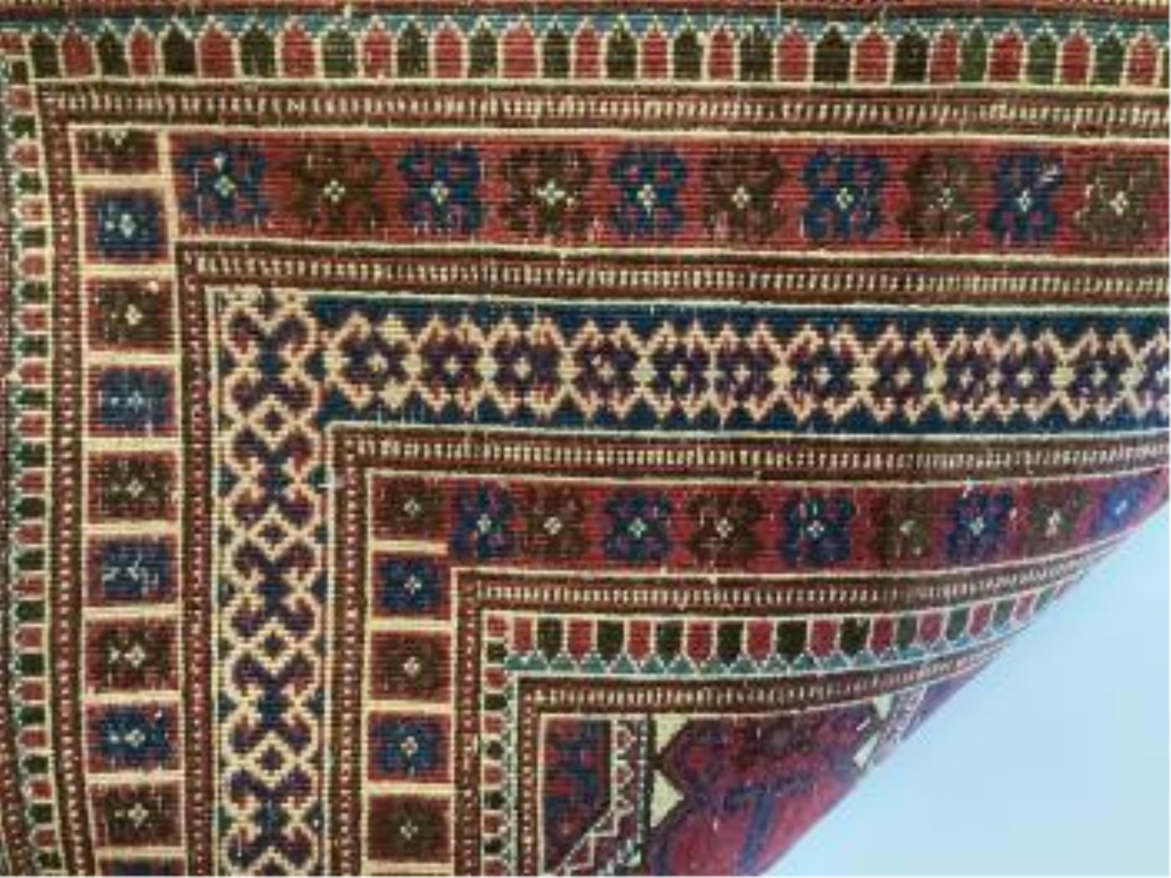 A Bokhara red ground rug, 191 x 124cm
